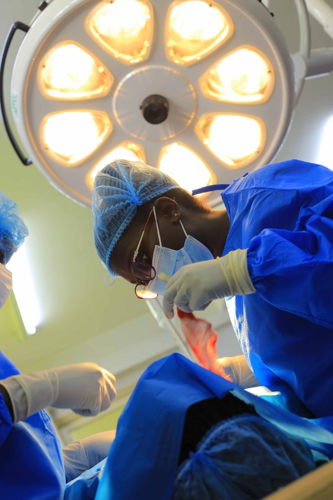 Dr. Sylvia Shitsama performing microsurgical cranial surgery under theatre illumination